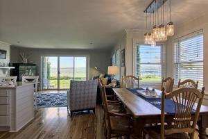 a kitchen and dining room with a table and chairs at 115 Water Street Inn in Boyne City