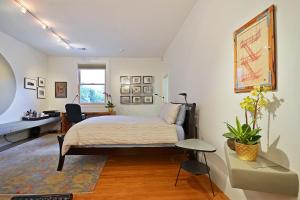 a bedroom with a bed and a desk and a window at Loft in Lower Nob Hill in San Francisco