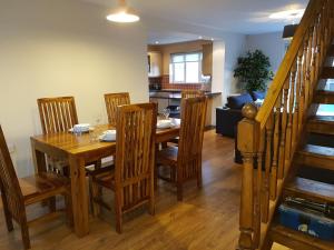 a kitchen and dining room with a wooden table and chairs at Moorland House in Syston +6 photos