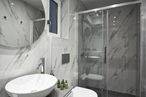a bathroom with a toilet and a sink and a shower at Valaoritou Boutique Apartment,Kolonaki in Athens +13 photos