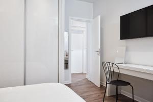 a bedroom with a bed and a desk and a chair at Valaoritou Boutique Apartment,Kolonaki in Athens