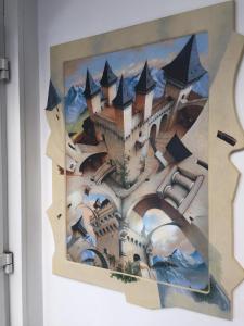 a painting of a castle on a wall at WOHLFÜHLOASE - Zimmer, Appartment - im Herzen STARNBERGS in Starnberg