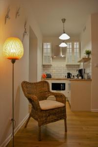 a living room with a chair and a lamp at MARINA Park Apartment in Świnoujście