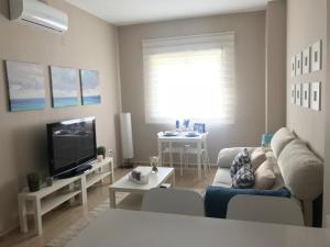 Telewizja i/lub zestaw kina domowego w obiekcie Apartamento DELUXE Benalmádena