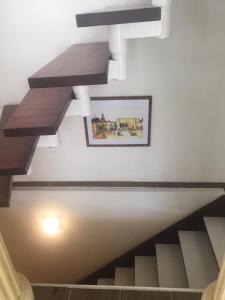 a staircase in a building with a picture on the wall at WOHLFÜHLOASE - Zimmer, Appartment - im Herzen STARNBERGS in Starnberg