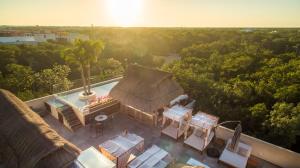 an aerial view of a house with a roof at Albra Tulum in Tulum