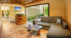 a living room with a couch and a fireplace at Albra Tulum in Tulum