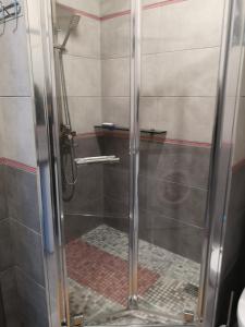 a shower with a glass door in a bathroom at Элитная квартира в Аркадии с видом на море 26 Жемчужина in Odesa +16 photos