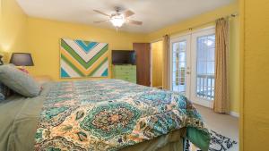 a bedroom with a bed with a colorful bedspread at Lands End in Ruidoso