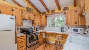 a kitchen with wooden cabinets and a white refrigerator at Lands End in Ruidoso