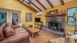 a living room with a couch and a fireplace at Lands End in Ruidoso