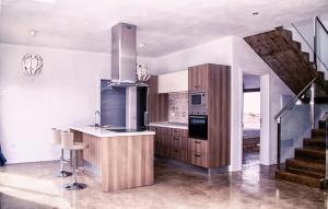 a kitchen with a counter and a staircase in a house at Casa De La Nobleza in Tinajo