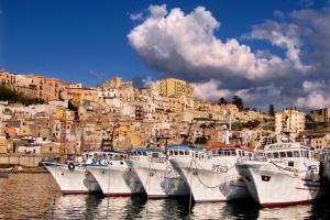 a group of boats docked in the water near a city at Bed and Breakfast Conte Luna in Sciacca