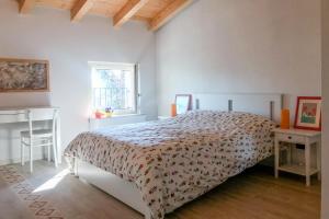 a white bedroom with a bed and a window at Agriturismo Croce del Gal in Verona