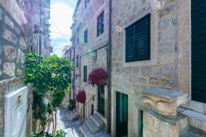an alley in an old town with buildings at Solis Rooms Old Town in Dubrovnik
