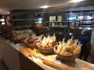 a bakery with baskets of bread on a counter at Landscape Beira mar in Fortaleza