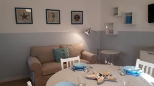 a living room with a table and a couch at Senigallia d'aMare in Senigallia +23 photos