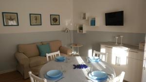 a living room with a table and a couch at Senigallia d'aMare in Senigallia