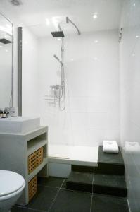a white bathroom with a shower and a toilet at History-chic in OldTown, beach in Nice
