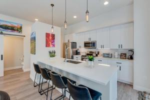 a kitchen with white cabinets and a large white island at New Luxury Loft #14 With Huge Hot Tub & Great Views - 500 Dollars Of FREE Activities & Equipment Rentals Daily in Winter Park