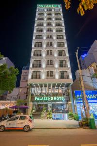 a tall building with a car parked in front of it at Palazzo 3 Danang Hotel in Da Nang