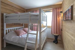 a bunk bed in a room with a ladder at Phoenix 101 in Tignes