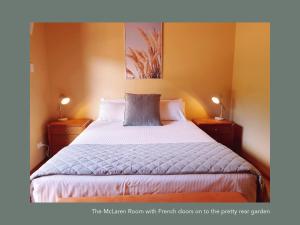 een slaapkamer met een groot bed met 2 nachtkastjes bij Chapel Hill Winery Guest House in McLaren Vale