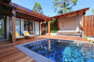 a house with a swimming pool on a wooden deck at CHUZ Villas Samui SHA Plus in Lamai