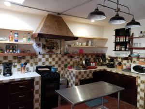 a kitchen with a stove and a table in it at La Abuelita Hostal in San Cristóbal de Las Casas