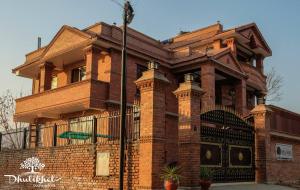 a large brick building with a pole in front of it at Dhulikhel boutique hotel in Dhulikhel