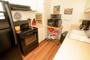a kitchen with a black stove and a sink at Discovery 4 #115 in Mammoth Lakes