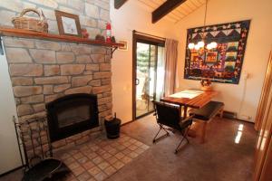 a living room with a stone fireplace and a table at Discovery 4 #128, Loft in Mammoth Lakes