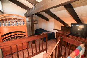a living room with a tv and a crib at Discovery 4 #128, Loft in Mammoth Lakes
