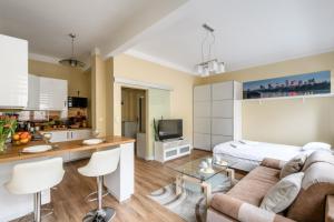 un soggiorno con divano e cucina di Studio Tamka by BookingHost a Varsavia