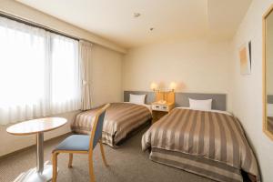 
A bed or beds in a room at Ark Hotel Hiroshimaeki Minami
