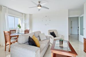 a living room with a couch and a table at Del Parque Flats - Torrevigia in Cala del Moral