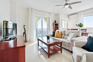 a living room with a couch and a table at Del Parque Flats - Torrevigia in Cala del Moral