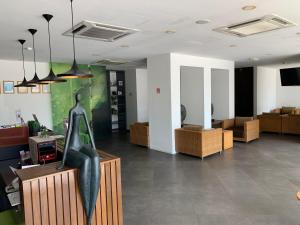 a room with a statue of a woman sitting on a counter at T+ Hotel Sungai Petani in Sungai Petani