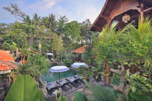 an overhead view of a resort pool with umbrellas at Batu Agung Villa Ubud in Ubud