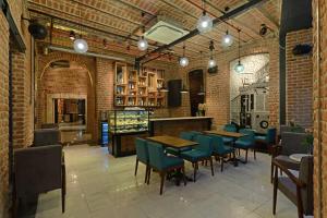 a restaurant with tables and chairs in a brick room at Régie Ottoman Istanbul - Special Category in Istanbul