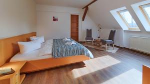 Postel nebo postele na pokoji v ubytování Hotel Luther Birke Wittenberg + 37 fotografií