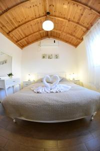 a bedroom with a large bed with a white bow on it at Suites & Spa Galilee in Qiryat Shemona