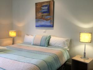 a bedroom with a bed and a lamp at Kilcunda Ocean View Motel in Kilcunda