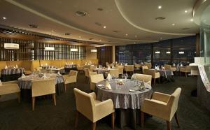 a dining room with tables and chairs and tablesearcher at Better Residence Suite at Times Square KL in Kuala Lumpur