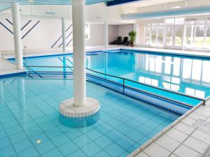 a large swimming pool in a large building at Amelander Kaap 39 in Hollum