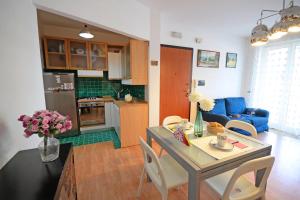ヴァストにあるAppartamento Il Faro - MyHo Casaのキッチン、リビングルーム(テーブル、椅子付)