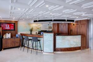 a lobby with a bar with stools in it at Armon Hayarkon Hotel in Tel Aviv