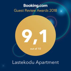 a sign that reads guest review awards with a yellow circle at Lastekodu Apartment in Tallinn