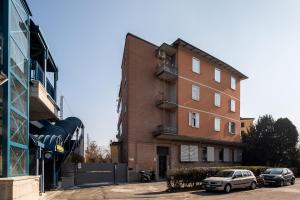 a building with cars parked in front of it at Aparthotel Sant'Orsola in Bologna