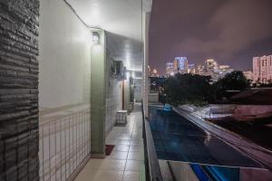 a balcony with a view of a city at night at RedDoorz Plus near Semanggi in Jakarta